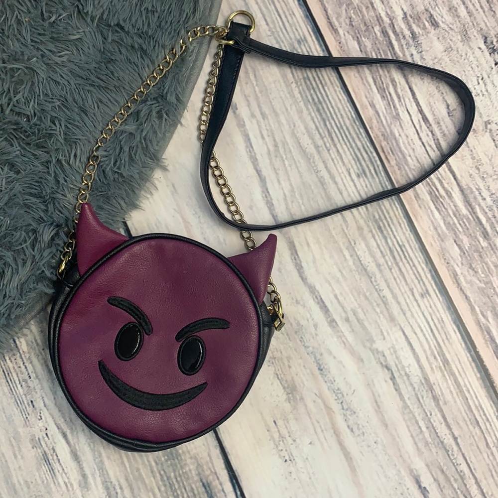 Purple Evil Emoji Crossbody Bag by Olivia Miller
